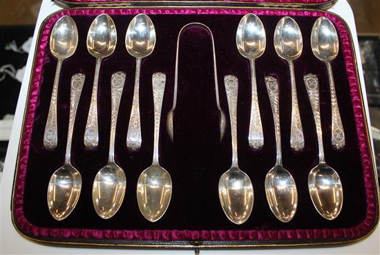 A Victorian cased set of 12 silver coffee spoons and a pair of tongs